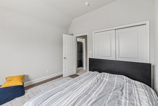 3328 Roseford Blvd, Ann Arbor, MI 48105 - bedroom with wood finished floors, vaulted ceiling, baseboards, and a closet