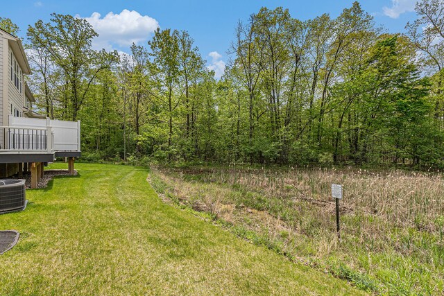3328 Roseford Blvd, Ann Arbor, MI 48105 - view of green lawn featuring cooling unit and a wooden deck