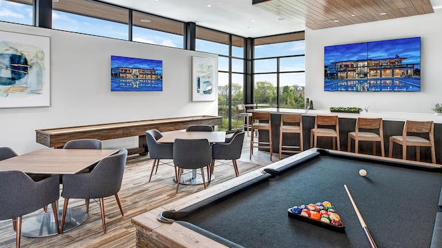 3328 Roseford Blvd, Ann Arbor, MI 48105 - playroom featuring billiards, wet bar, a wall of windows, and wood finished floors