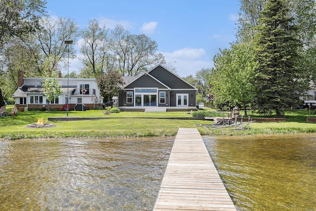 9693 Beverly Dr, Lakeland, MI 48143 - dock with an outdoor fire pit, a water view, and a yard