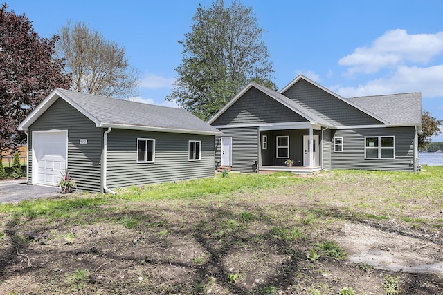9693 Beverly Dr, Lakeland, MI 48143 - view of front of home featuring covered porch and an outbuilding
