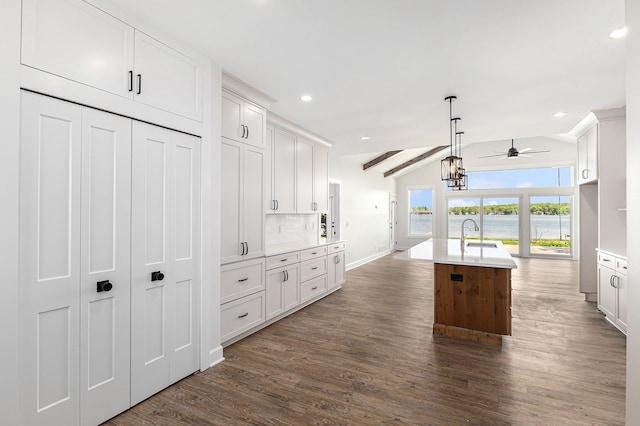 9693 Beverly Dr, Lakeland, MI 48143 - kitchen with a ceiling fan, dark wood finished floors, vaulted ceiling, a sink, and light countertops