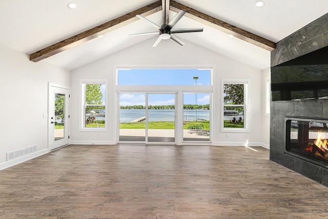 9693 Beverly Dr, Lakeland, MI 48143 - unfurnished living room featuring a tiled fireplace, beam ceiling, baseboards, dark wood-type flooring, and a ceiling fan