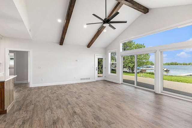 9693 Beverly Dr, Lakeland, MI 48143 - unfurnished living room with high vaulted ceiling, a water view, beam ceiling, a ceiling fan, and baseboards