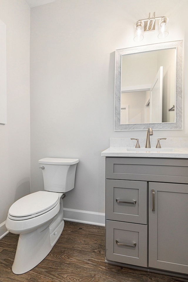 9693 Beverly Dr, Lakeland, MI 48143 - half bath with baseboards, wood finished floors, and vanity