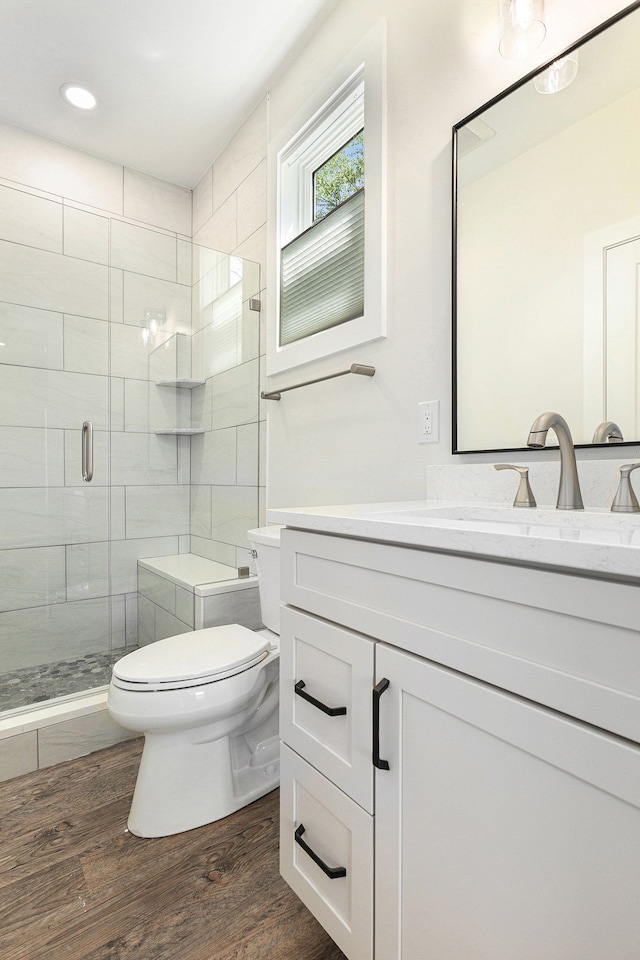 9693 Beverly Dr, Lakeland, MI 48143 - bathroom with toilet, wood finished floors, a shower stall, vanity, and recessed lighting