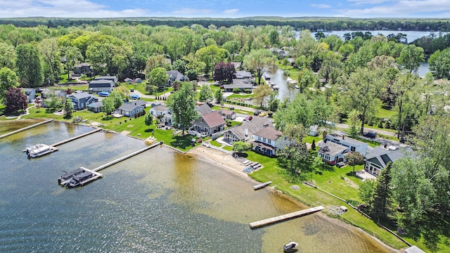 9693 Beverly Dr, Lakeland, MI 48143 - aerial overview of property's location with a heavily wooded area, a large body of water, and nearby suburban area