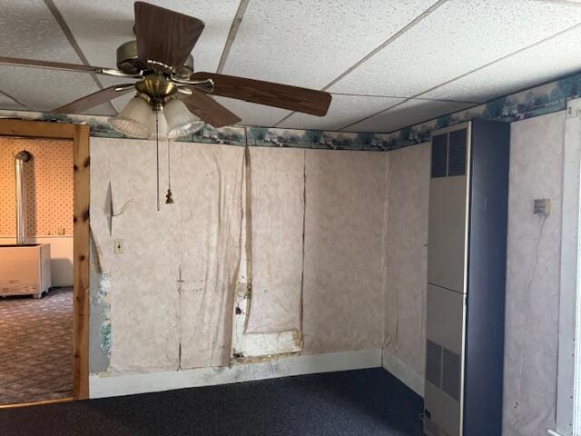 below grade area with a ceiling fan and a heating unit