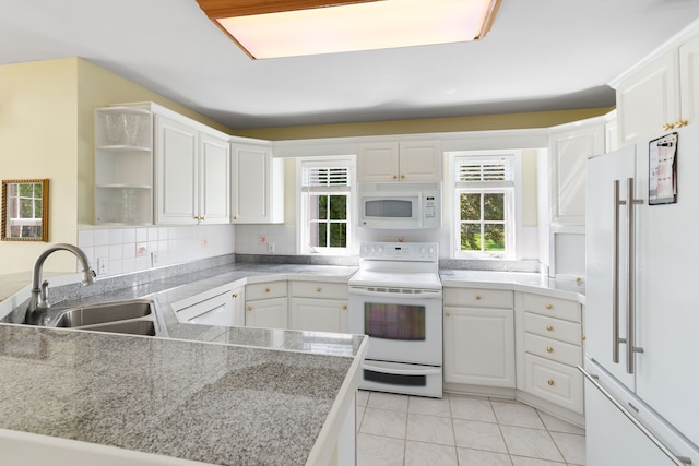 kitchen with white appliances, a sink, open shelves, white cabinetry, and plenty of natural light