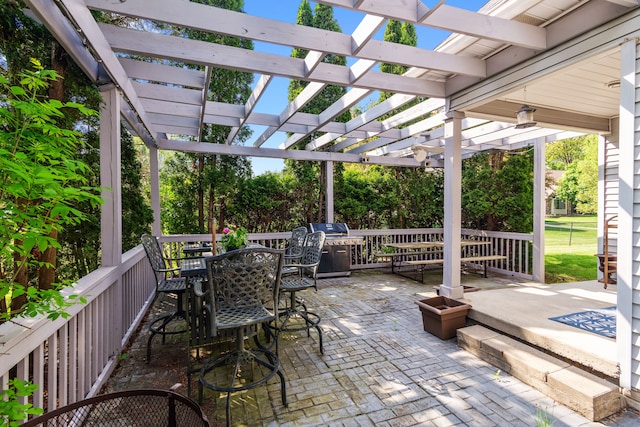 view of patio featuring a pergola and outdoor dining space