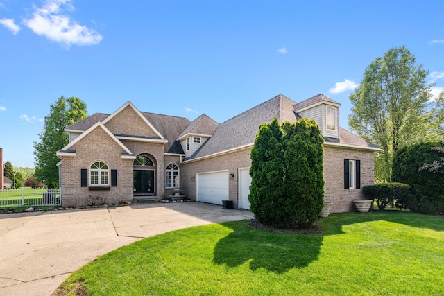 traditional-style house featuring brick siding, concrete driveway, a garage, and a shingled roof