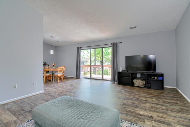 35844 Castlewood Ct, Westland, MI 48185 - living room featuring wood finished floors, baseboards, and a textured ceiling