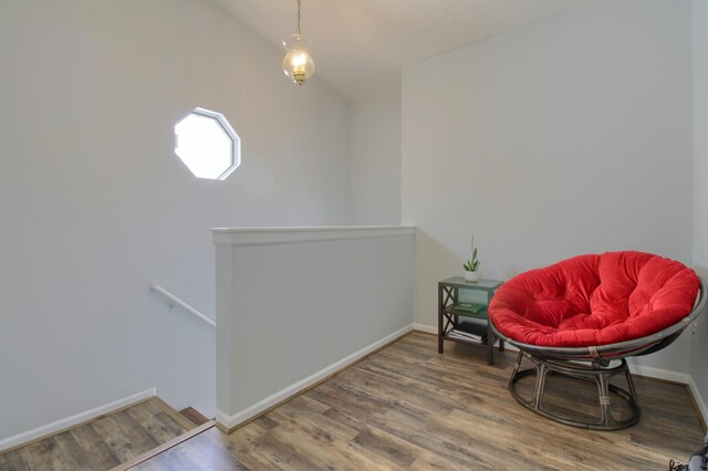 35844 Castlewood Ct, Westland, MI 48185 - living area with an upstairs landing, wood finished floors, baseboards, and lofted ceiling