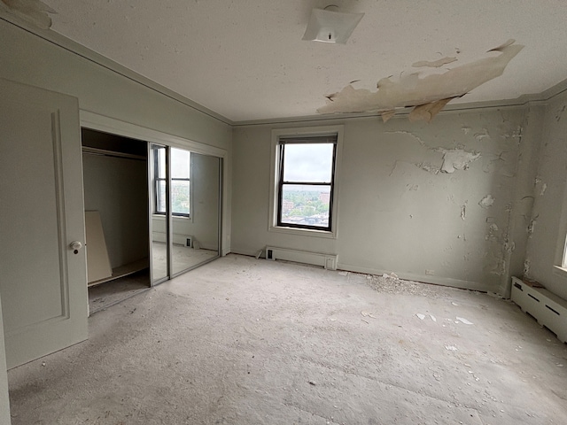 8162 E Jefferson Ave Unit 16B, Detroit, MI 48214 - unfurnished bedroom with a closet and baseboard heating