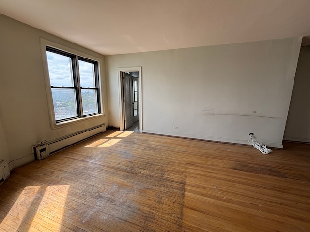 8162 E Jefferson Ave Unit 16B, Detroit, MI 48214 - spare room with a baseboard heating unit, hardwood / wood-style floors, and baseboards