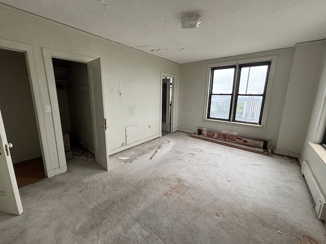 8162 E Jefferson Ave Unit 16B, Detroit, MI 48214 - unfurnished bedroom with carpet and a baseboard radiator