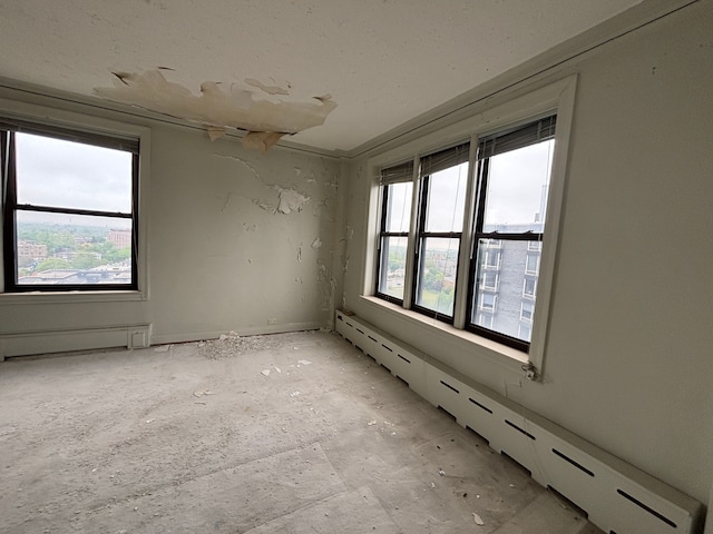 8162 E Jefferson Ave Unit 16B, Detroit, MI 48214 - spare room with healthy amount of natural light and a baseboard heating unit