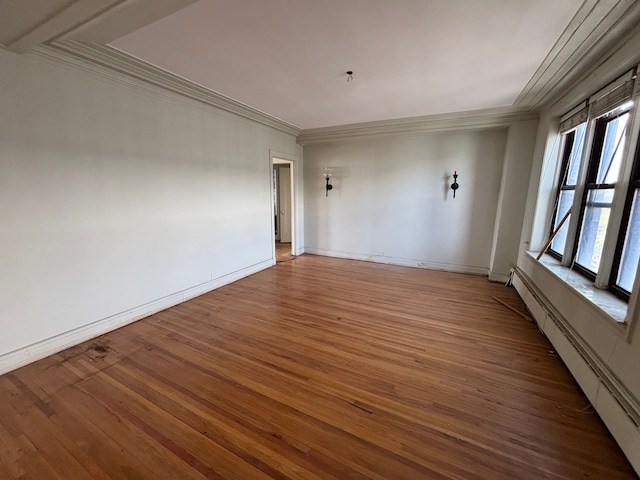 8162 E Jefferson Ave Unit 16B, Detroit, MI 48214 - spare room featuring a baseboard radiator, ornamental molding, wood finished floors, and baseboards