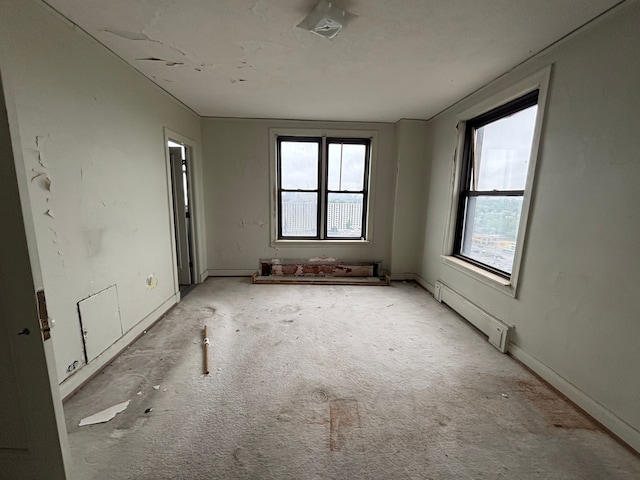 8162 E Jefferson Ave Unit 16B, Detroit, MI 48214 - spare room featuring healthy amount of natural light, a baseboard radiator, and carpet