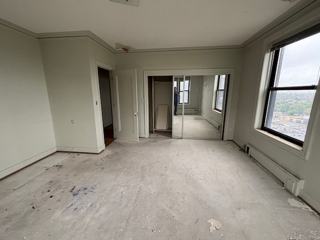 8162 E Jefferson Ave Unit 16B, Detroit, MI 48214 - unfurnished bedroom featuring a baseboard radiator, baseboard heating, and a closet