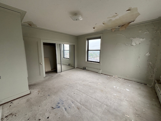 8162 E Jefferson Ave Unit 16B, Detroit, MI 48214 - unfurnished bedroom featuring baseboard heating and a closet