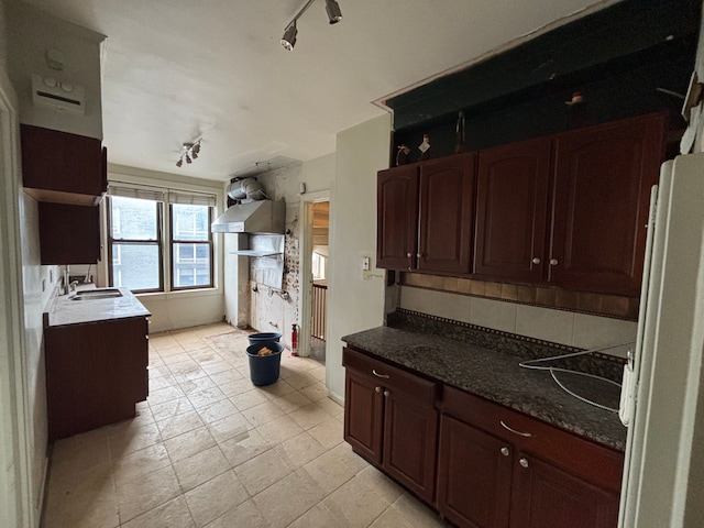 8162 E Jefferson Ave Unit 16B, Detroit, MI 48214 - kitchen featuring a sink, decorative backsplash, wall chimney exhaust hood, and freestanding refrigerator