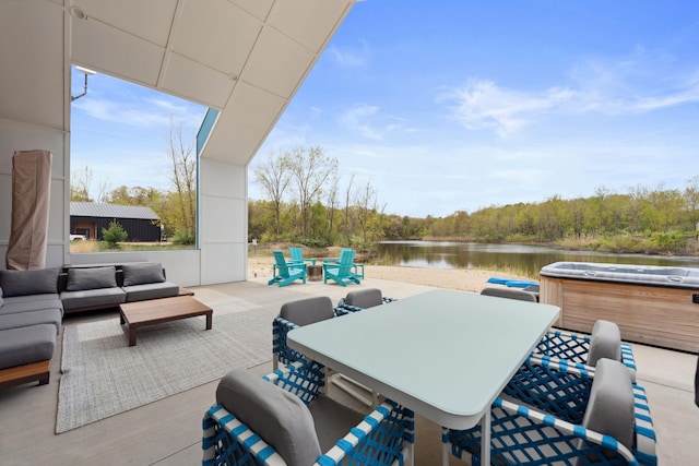 7469 Lake Solis Dr, Stevensville, MI 49127 - view of patio with a hot tub, a water view, an outdoor hangout area, outdoor dining space, and a view of trees