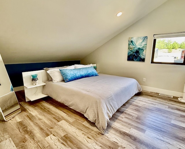 7469 Lake Solis Dr, Stevensville, MI 49127 - bedroom featuring vaulted ceiling, wood finished floors, baseboards, and recessed lighting