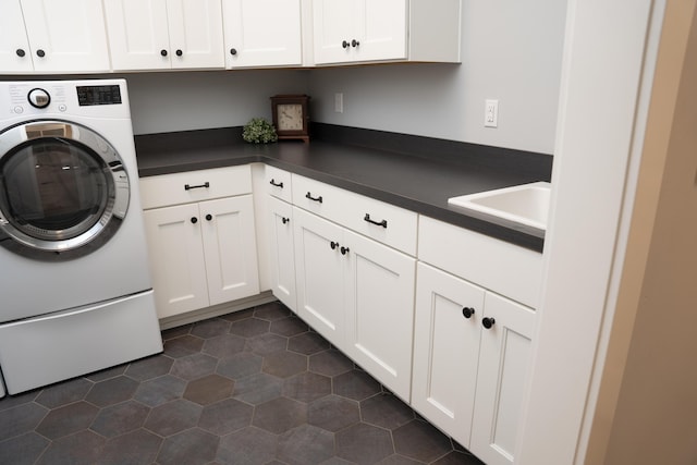 8182 Country Rail Dr SW, Byron Center, MI 49315 - laundry room featuring cabinet space, washer / clothes dryer, and dark tile patterned floors