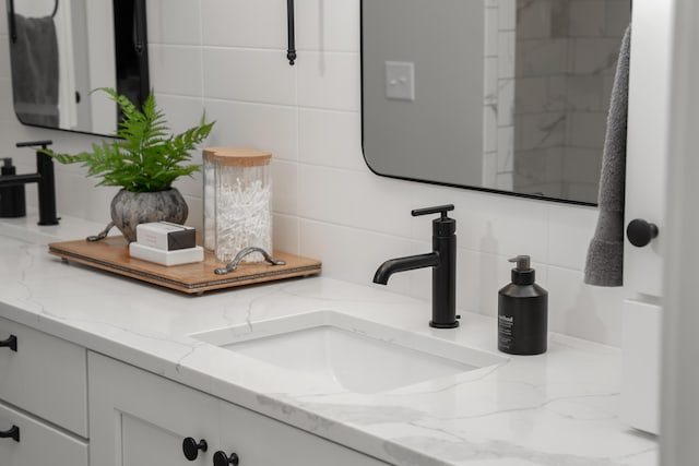 8182 Country Rail Dr SW, Byron Center, MI 49315 - bathroom with decorative backsplash and vanity
