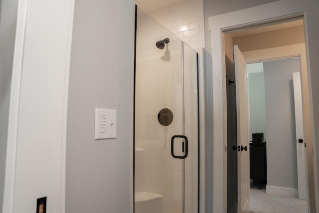 8182 Country Rail Dr SW, Byron Center, MI 49315 - bathroom featuring a stall shower and baseboards