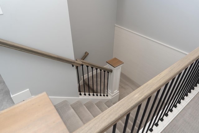 8182 Country Rail Dr SW, Byron Center, MI 49315 - stairway with carpet flooring and a wainscoted wall
