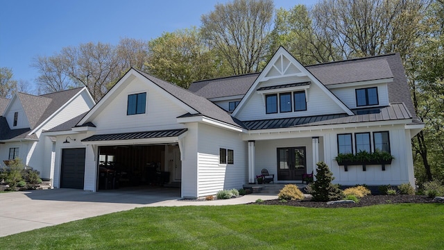 8182 Country Rail Dr SW, Byron Center, MI 49315 - modern inspired farmhouse featuring a standing seam roof, concrete driveway, a front yard, board and batten siding, and french doors