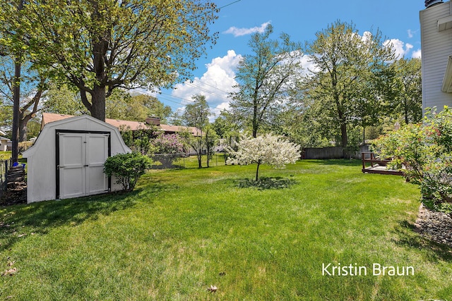 view of yard featuring a storage shed and an outbuilding