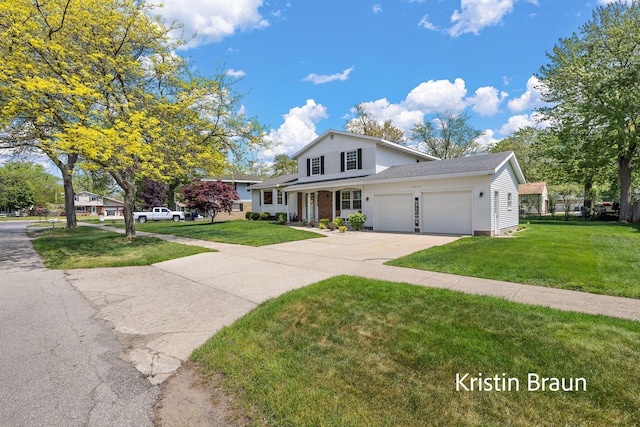 traditional-style house with an attached garage, driveway, and a front lawn