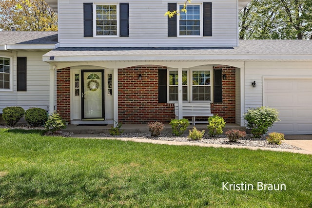 property entrance featuring a porch, a lawn, brick siding, and a shingled roof