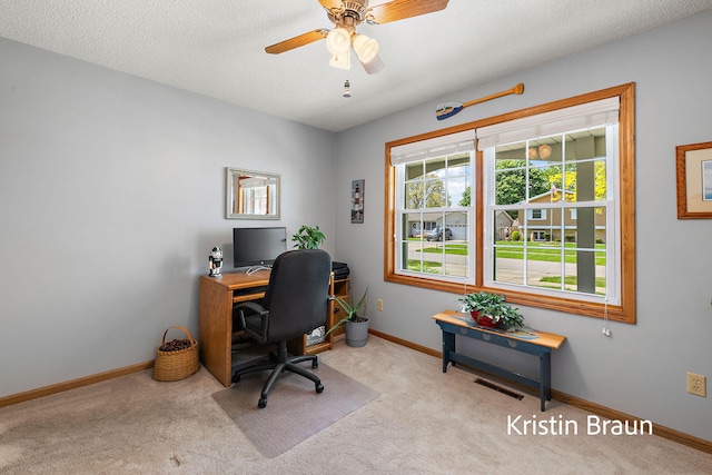 office space featuring carpet, baseboards, and a ceiling fan