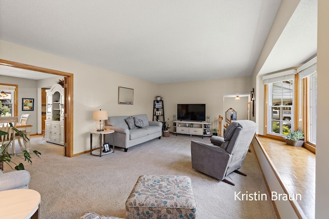 living room featuring light carpet and baseboards