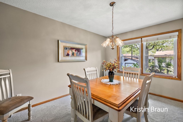 dining space with carpet, baseboards, a chandelier, and a textured ceiling