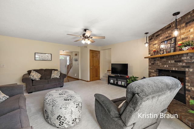 carpeted living area with a ceiling fan and a brick fireplace
