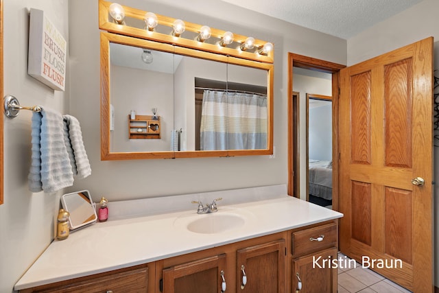 bathroom featuring vanity, tile patterned floors, a textured ceiling, and a shower with shower curtain