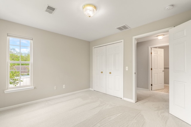 2781 Knightsbridge Cir Unit 72, Ann Arbor, MI 48105 - unfurnished bedroom featuring baseboards, light carpet, and a closet