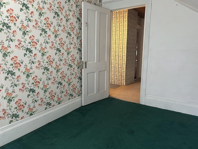 1902 W Ogilvie Ave, Baldwin, MI 49304 - spare room featuring wallpapered walls and dark colored carpet