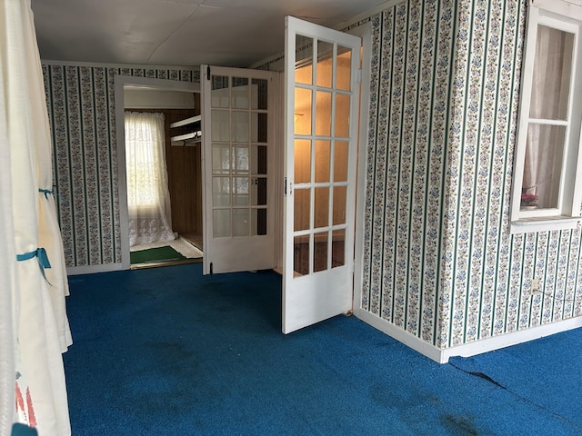 1902 W Ogilvie Ave, Baldwin, MI 49304 - spare room featuring wallpapered walls, carpet, and french doors