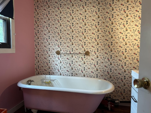 1902 W Ogilvie Ave, Baldwin, MI 49304 - bathroom featuring baseboards, a freestanding bath, vanity, and wood finished floors