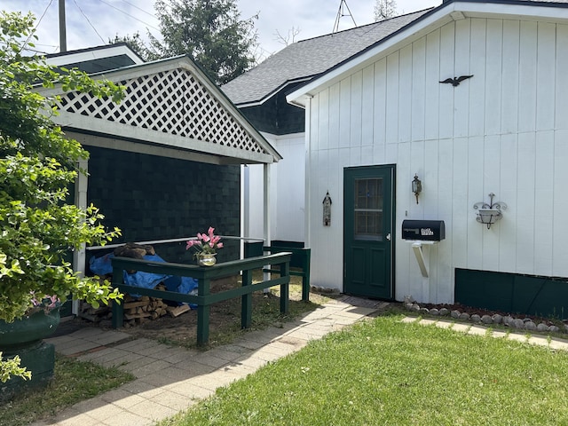 1902 W Ogilvie Ave, Baldwin, MI 49304 - doorway to property with roof with shingles and a yard