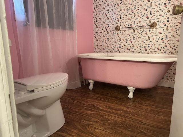 1902 W Ogilvie Ave, Baldwin, MI 49304 - bathroom with toilet, a freestanding bath, and wood finished floors