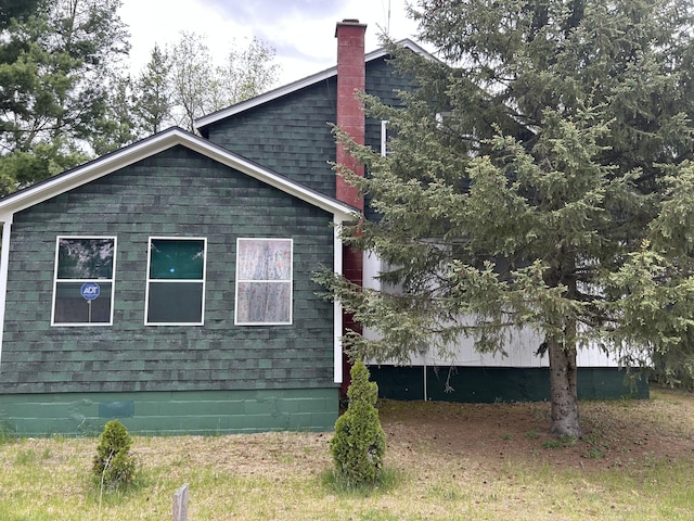 1902 W Ogilvie Ave, Baldwin, MI 49304 - view of side of home with a chimney