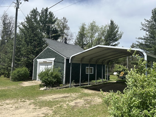 1902 W Ogilvie Ave, Baldwin, MI 49304 - view of parking featuring a detached garage