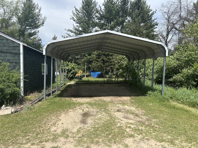 1902 W Ogilvie Ave, Baldwin, MI 49304 - view of parking / parking lot featuring a carport and driveway